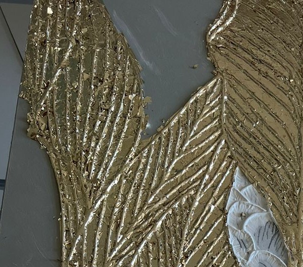 Macro detail of sculpted gold leaf relief